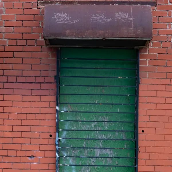 Green Metal Door & Brick